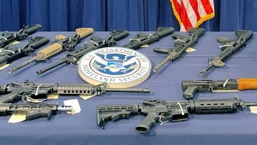 Seized weapons are displayed during a news conference in Miami