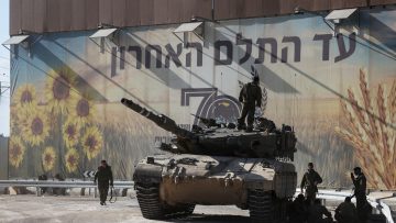Israeli soldiers gather on and around a tank near Israel’s border with the Gaza Strip, in southern Israel