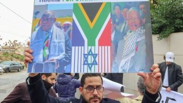Demonstrators protest as judges at the ICJ in the Hague hear a request for emergency measures to order Israel to stop its military actions in Gaza, in Amman